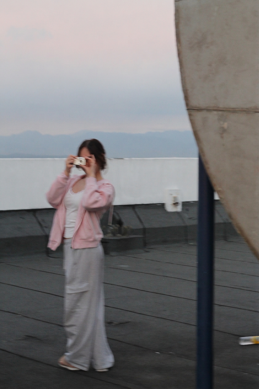 amy taking a mirror photo on a rooftop